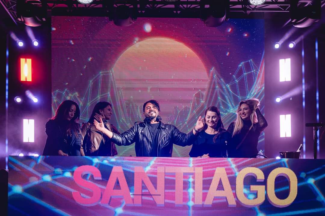 Santiago Cortes performing live DJ set with dancers on stage